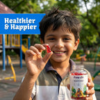 Child holding a supplement bottle and a red chewable Strawberry bear shape gummy outdoors with playground equipment in the background. Child hold a smile on his face with a bold text of Healthier & Happier.  