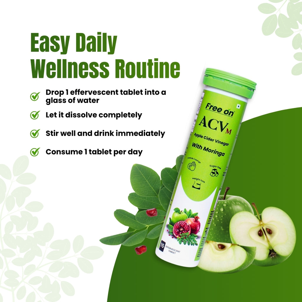 A tall, slender white and green tube of Free On ACVm effervescent tablets. The label highlights "Apple Cider Vinegar With Moringa" and includes icons for "Controls Cravings," "Sugar Free," and "Weight Loss."
The product is surrounded by green moringa leaves, whole and sliced green apples, and pomegranate seeds.
"Easy Daily Wellness Routine" in bold, green sans-serif font. with mention FreeOn Apple Cider Vinegar with Moringa for aily natural weightloss management 