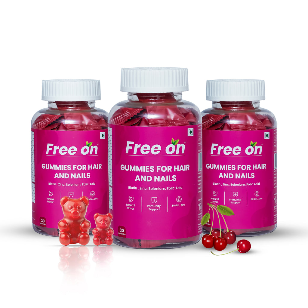 Three bottles of Free on Gummies for Hair and Nails with gummy bears and cherries on a white background