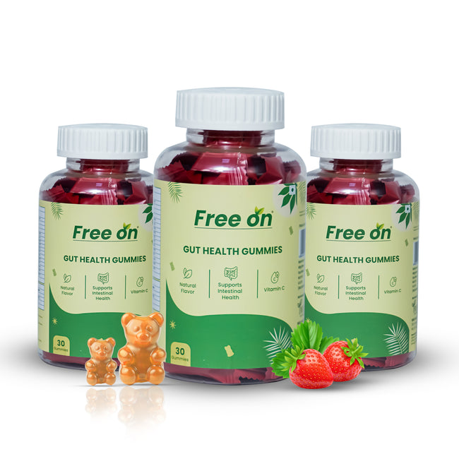 Three bottles of Free on Gut Health Gummies with gummy bears and strawberries on a white background Hover Image