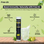 Free On supplement tube with a glass of liquid and apples on a wooden surface, against a green background. Displaying the product features Boost Immunity, Rich in Atioxidants, Supports Detoification & Enhances Skin Health with website www.imiahealthcare.com mention at bttom of the picture 